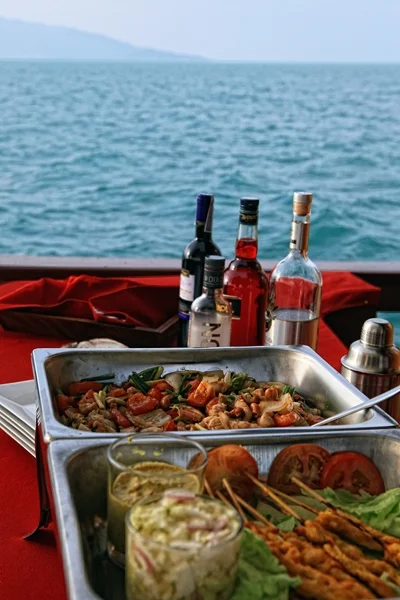 Buffet spread with seafood and Thai dishes on Red Baron